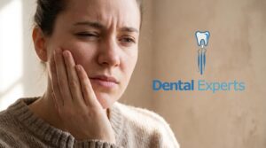 Person experiencing tooth pain and touching their jaw